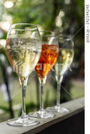 different iced spritzer wine cocktail drinks at outdoor garden bar party on sunny day 142144248