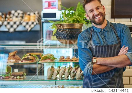 Portrait, businessman and happiness in cafe for startup company, restaurant and pride for work. Male person, small business owner and smile for nutrition and health in coffee shop in New York 142144441