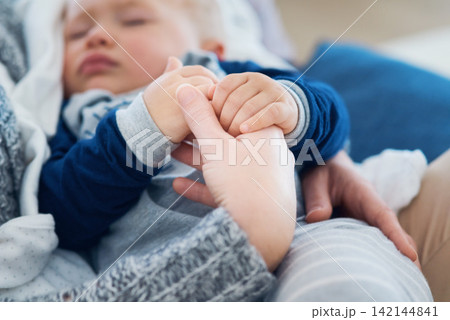 Mommy, baby and sleeping for holding hands in home, security and support in bonding for wellness. Mother, toddler and care for maternity or nap on couch, child development and comfort for single mom Mommy, baby and sleeping for holding hands in home, security and support in bonding for wellness. Mother, toddler and care for maternity or nap on couch, child development and comfort for single mom 142144841