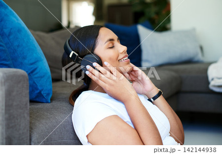 Relax, headphones and woman on sofa in home with podcast, streaming subscription and smile. Music, online and girl in living room with service for internet radio, happy connection and audio. 142144938