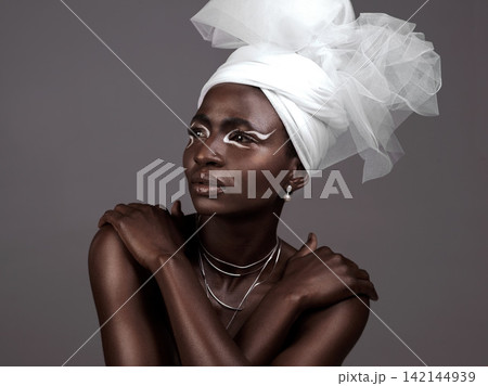 Thinking, wrap or black woman with makeup, fashion or beauty in studio on grey background. Skincare, turban or African model with traditional outfit, eyeshadow cosmetics or necklace for culture pride Thinking, wrap or black woman with makeup, fashion or beauty in studio on grey background. Skincare, turban or African model with traditional outfit, eyeshadow cosmetics or necklace for culture pride 142144939