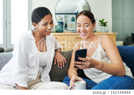 Happy woman, friends and laughing with phone on sofa for social media, communication or funny joke at home. Female person with smile on mobile smartphone for friendly chat or online browsing at house Happy woman, friends and laughing with phone on sofa for social media, communication or funny joke at home. Female person with smile on mobile smartphone for friendly chat or online browsing at house 142144984