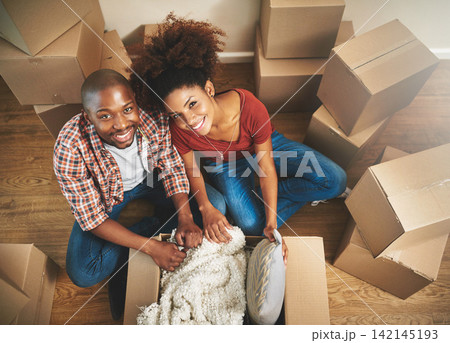 Portrait, boxes and black couple on floor in new home with moving, smile and mortgage with top view. Relax, man and happy woman in apartment together with packing, love and property investment. Portrait, boxes and black couple on floor in new home with moving, smile and mortgage with top view. Relax, man and happy woman in apartment together with packing, love and property investment. 142145193