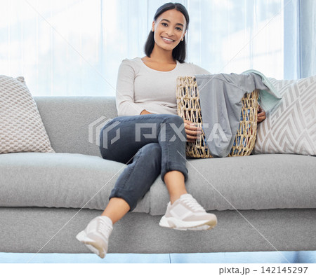 Couch, laundry and portrait of woman with basket for house work, cleaning service and weekend maintenance. Female cleaner, sofa and smile in living room with container for clothes, fabric and hygiene Couch, laundry and portrait of woman with basket for house work, cleaning service and weekend maintenance. Female cleaner, sofa and smile in living room with container for clothes, fabric and hygiene 142145297