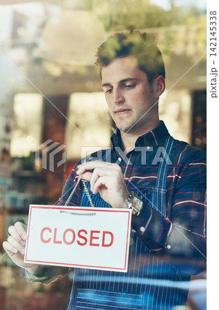 Closed, sign and waiter at door of store for restaurant, information and notification of service. Coffee shop, man and person with board by window for small business, hospitality and end of work day 142145338