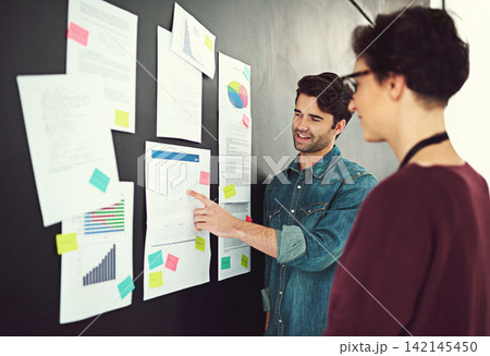Creative man, coach and meeting with calendar for schedule planning, annual goals or notes at office. Male person or speaker with colleague, coworker or employee for startup, discussion or business 142145450