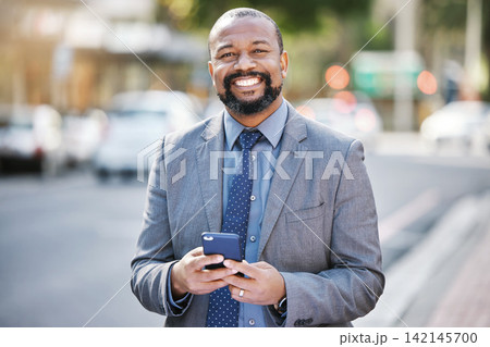 Business, portrait and black man with phone in city for social media, networking and consultant outdoor in Kenya. Mobile, happy professional and face of entrepreneur, worker and employee in street Business, portrait and black man with phone in city for social media, networking and consultant outdoor in Kenya. Mobile, happy professional and face of entrepreneur, worker and employee in street 142145700