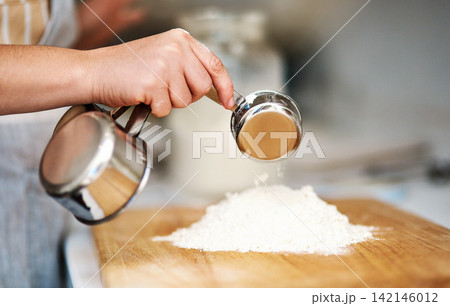 Hands, kitchen and flour for baking, home and glass bowl for dessert or small business. Baker, ingredients and measurement with cup, house or startup bakery for recipe prepare and sweet food process 142146012