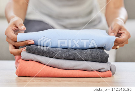 Woman, hands and laundry with pile on sofa for clean clothing, chores or housekeeping at home. Closeup of female person, cleaner or maid with dry washing or stack for neat and tidy apartment or house Woman, hands and laundry with pile on sofa for clean clothing, chores or housekeeping at home. Closeup of female person, cleaner or maid with dry washing or stack for neat and tidy apartment or house 142146186