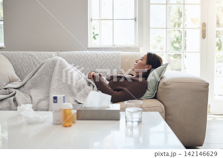 Woman, couch and sad or sick in home, cold and medicine for illness and treatment for health. Female person, blanket and virus on sofa for burnout, pills and stress for crisis or pain and drugs Woman, couch and sad or sick in home, cold and medicine for illness and treatment for health. Female person, blanket and virus on sofa for burnout, pills and stress for crisis or pain and drugs 142146629