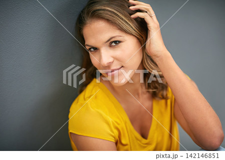 Young woman, beauty and hand in portrait with smile for confidence and pride in hair treatment isolated in studio. Female person or model and haircare for glow with keratin formula on gray background 142146851