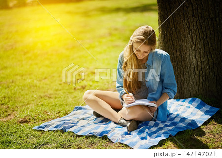 Young woman, happy and notebook for study in nature for test, education and scholarship in countryside. Female student, gen z and paper by tree for learning, reading and smile for brainstorming Young woman, happy and notebook for study in nature for test, education and scholarship in countryside. Female student, gen z and paper by tree for learning, reading and smile for brainstorming 142147021