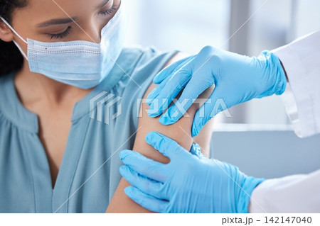 Patient, face mask and doctor hands for injection of virus cure for vaccination, pandemic or immunity. Person, arm and gloves in hospital with ppe protection for .Influenza bacteria, safety or shot Patient, face mask and doctor hands for injection of virus cure for vaccination, pandemic or immunity. Person, arm and gloves in hospital with ppe protection for .Influenza bacteria, safety or shot 142147040