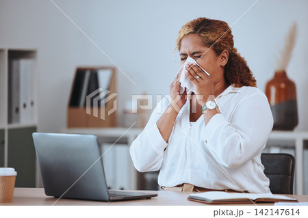 Woman, sick and blowing nose in office with tissue for sneeze, allergies or sinusitis with laptop. Person, employee and toilet paper to stop bacteria, health and cleaning face with flu in workplace Woman, sick and blowing nose in office with tissue for sneeze, allergies or sinusitis with laptop. Person, employee and toilet paper to stop bacteria, health and cleaning face with flu in workplace 142147614