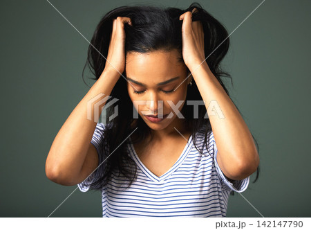 Stress, pull hair or woman with anxiety in studio for burnout, mistake or mental health crisis in depression. Frustrated, trauma or upset girl worried by bad news and loss isolated on grey background Stress, pull hair or woman with anxiety in studio for burnout, mistake or mental health crisis in depression. Frustrated, trauma or upset girl worried by bad news and loss isolated on grey background 142147790
