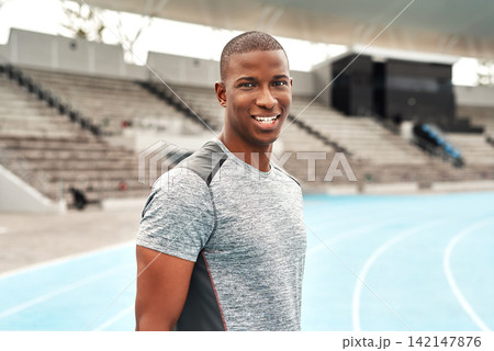 Confident, black man or athlete portrait on sports track for fitness, running and training for competition. Male person, sportswear and outdoor on marathon field for workout, exercise and health Confident, black man or athlete portrait on sports track for fitness, running and training for competition. Male person, sportswear and outdoor on marathon field for workout, exercise and health 142147876