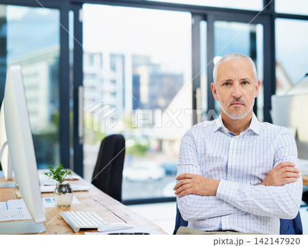 Mature man, confident and portrait in office, serious CEO and hr manager for recruitment. Male person, entrepreneur and proud of startup company or agency, arms crossed and assertive employee at desk 142147920