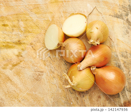 Fresh, food and nutrition in sliced, onions and background in kitchen or studio. Healthy, eating and recipe for wellness, health and cuisine with organic, vegetables and cooking for meal prep Fresh, food and nutrition in sliced, onions and background in kitchen or studio. Healthy, eating and recipe for wellness, health and cuisine with organic, vegetables and cooking for meal prep 142147936