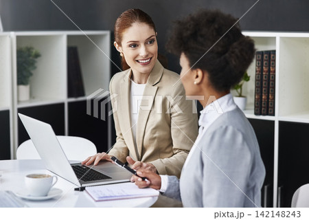 Teamwork, meeting or business women with laptop in office for support or speaking of research news. Talking, online or financial consultants in conversation, communication or discussion in workplace Teamwork, meeting or business women with laptop in office for support or speaking of research news. Talking, online or financial consultants in conversation, communication or discussion in workplace 142148243