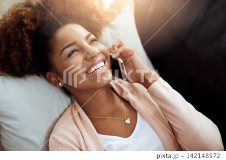 Woman, home and couch or relax on phone call, chatting and living room for comfort on smartphone with internet. Conversation, laugh and funny discussion, listening and connected for communication 142148572