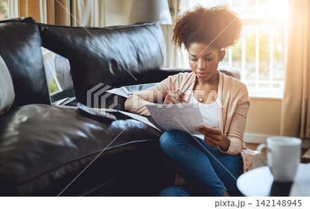 Budget, paperwork and black woman in home with bills, document and reading investment report. Wealth, savings or person planning future with income, info and strategy for tax with online research 142148945
