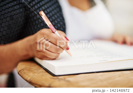 Person, hand and notebook with apron as cook writing in kitchen with ingredient experiment, bakery or small business. Pen, paper and dessert hobby in home as professional chef, recipe or learning Person, hand and notebook with apron as cook writing in kitchen with ingredient experiment, bakery or small business. Pen, paper and dessert hobby in home as professional chef, recipe or learning 142148972