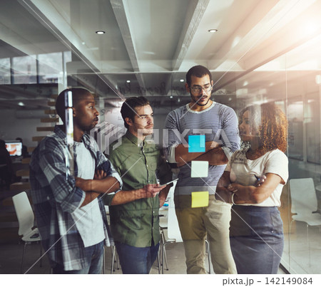 Business people, brainstorming and glass wall as teamwork project or information, ideas or startup. Men, women and partnership or collaboration on creative campaign or report, meeting or sticky notes 142149084