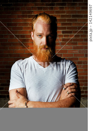 Man, portrait and confident outfit by brick wall, pride and rings or jewelry for tattoo style. Male person, serious face and gen z or arms crossed for aesthetic, designer clothes and weekend travel Man, portrait and confident outfit by brick wall, pride and rings or jewelry for tattoo style. Male person, serious face and gen z or arms crossed for aesthetic, designer clothes and weekend travel 142149697