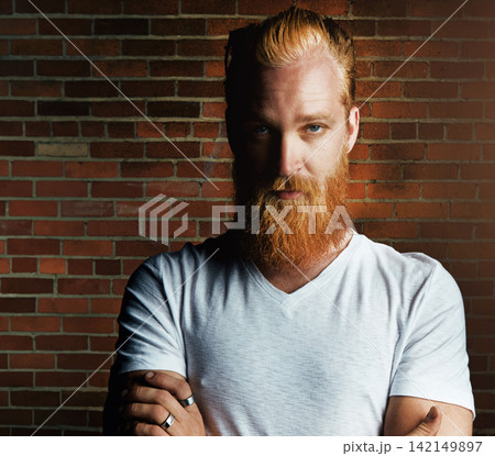 Man, portrait and confident fashion by brick wall, pride and rings or jewelry for style. Male person, serious face and gen z or casual outfit for aesthetic, minimalist clothes and weekend travel 142149897