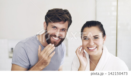 Portrait, bathroom or happy couple with face cream, skincare or funny joke for laughing, serum or product. Morning, man or woman with facial oil moisturizer for beauty, wellness or cleaning in home 142150473