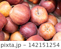Fresh ripe apples close-up. Fresh ripe apples with a beautiful red-yellow blush. Fruit and vegetable stand. Autumn harvest. 142151254