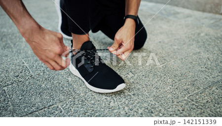 Person, runner or hands tie shoes to start workout, sports exercise or fitness training for running. Closeup, footwear or healthy athlete on sidewalk in urban town or city ready for sprinting or jog Person, runner or hands tie shoes to start workout, sports exercise or fitness training for running. Closeup, footwear or healthy athlete on sidewalk in urban town or city ready for sprinting or jog 142151339