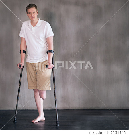 Portrait, crutches and man with disability in healthcare centre for walking, muscle strength and medical for support. Amputee, exercise and physiotherapy for physical therapy with rehabilitation Portrait, crutches and man with disability in healthcare centre for walking, muscle strength and medical for support. Amputee, exercise and physiotherapy for physical therapy with rehabilitation 142151543