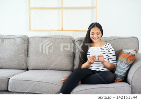 Child, tablet and sofa at home with elearning, online education and upskill app game. Living room, tech and digital reading with social media or youth development learning in a house with smile 142151544