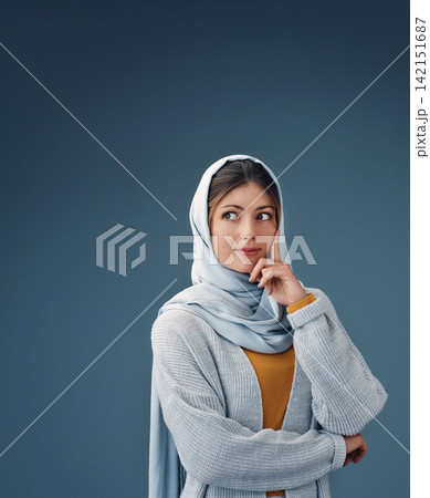 Fashion, thinking and muslim woman with idea in studio isolated on a blue background mockup space. Serious, dream and Islamic person in hijab for vision, inspiration or decision with casual clothes 142151687