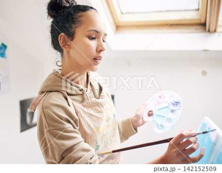 Woman, painting and palette in creative studio in house for art project, student and canvas. Artist, watercolor and design workshop for learning, exhibition and gen z girl with talent in apartment 142152509