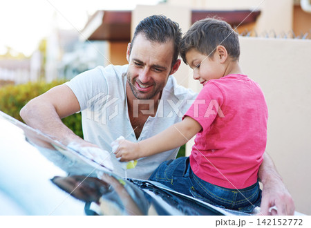 Chores, washing car and father with son in driveway of home in summer together for child development. Family, love or smile with happy parent and boy kid cleaning vehicle outdoor for responsibility Chores, washing car and father with son in driveway of home in summer together for child development. Family, love or smile with happy parent and boy kid cleaning vehicle outdoor for responsibility 142152772