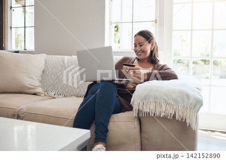 Woman, laptop and credit card on couch to pay, finance and website for online shopping in home. Female person, ecommerce and code for transfer or purchase, sofa and app for banking or budget on tech Woman, laptop and credit card on couch to pay, finance and website for online shopping in home. Female person, ecommerce and code for transfer or purchase, sofa and app for banking or budget on tech 142152890