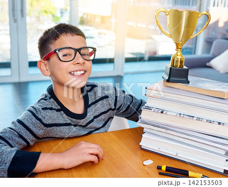 Portrait, child and smile of student with trophy for success, winning or education achievement in home. Face, kid and school reward of champion in glasses for learning competition or award in Germany 142153503
