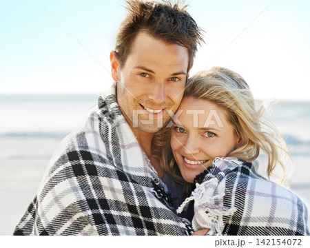 Couple, happy and blanket on beach with portrait for picnic, vacation and relax in summer by nature in love. Man, woman and embrace by ocean in Florida for adventure, holiday and freedom with smile Couple, happy and blanket on beach with portrait for picnic, vacation and relax in summer by nature in love. Man, woman and embrace by ocean in Florida for adventure, holiday and freedom with smile 142154072