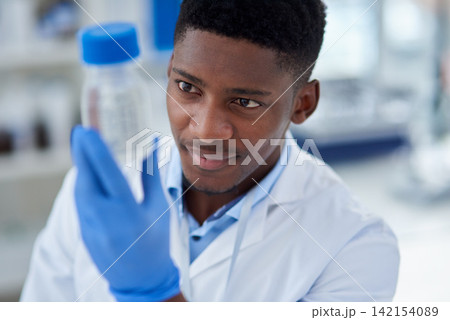 Science, research and black man with container, chemical or medical engineering in laboratory. Biotech, scientist or lab technician with liquid solution in vaccine study for pharmaceutical innovation Science, research and black man with container, chemical or medical engineering in laboratory. Biotech, scientist or lab technician with liquid solution in vaccine study for pharmaceutical innovation 142154089