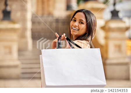Portrait, shopping bag and woman in city happy on urban street for boutique, retail and clothing sale. Female person, packages and smile outdoors with luxury products for fashionable rich customer 142154353