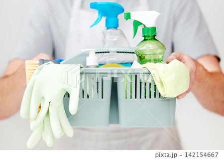 Man, hands and container with cleaning supplies in studio for spring cleaner, bacteria and housekeeping. Person, basket and hygiene product for housework and household chores on white background Man, hands and container with cleaning supplies in studio for spring cleaner, bacteria and housekeeping. Person, basket and hygiene product for housework and household chores on white background 142154667
