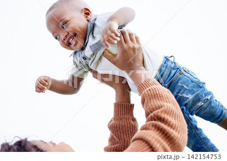 Mother, lifting baby and playing outdoor, fun and energy with airplane, family for bonding and love. Happiness, comfort and security with playful mood, woman and little boy with flying games and joy 142154753