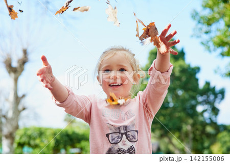 Autumn, leaves and girl play with freedom outdoor and relax on Thanksgiving, holiday or vacation. Happy, child and games in backyard playground, park and hands with leaf from trees in garden or woods Autumn, leaves and girl play with freedom outdoor and relax on Thanksgiving, holiday or vacation. Happy, child and games in backyard playground, park and hands with leaf from trees in garden or woods 142155006
