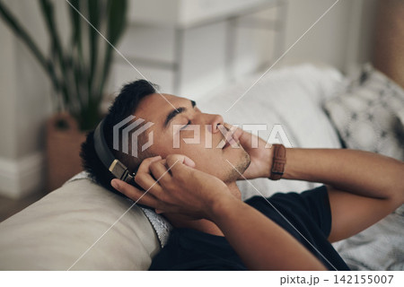 Home, relax and man with headphones, listening to music and peaceful with wellness and zen. Person, apartment and guy with headset and streaming podcast with break and resting with sound and song Home, relax and man with headphones, listening to music and peaceful with wellness and zen. Person, apartment and guy with headset and streaming podcast with break and resting with sound and song 142155007