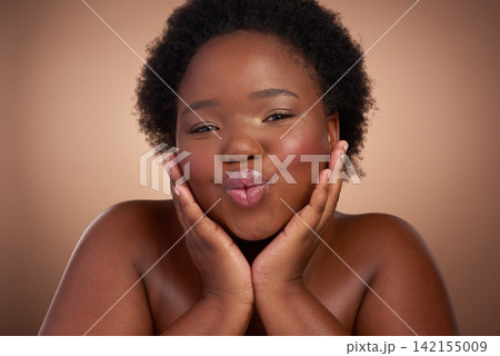 Kiss, portrait and black woman in studio for beauty or skincare with make up, cosmetics and wellness. Person, isolated and beige background with lip balm for glow or self care, aesthetic and pout. 142155009