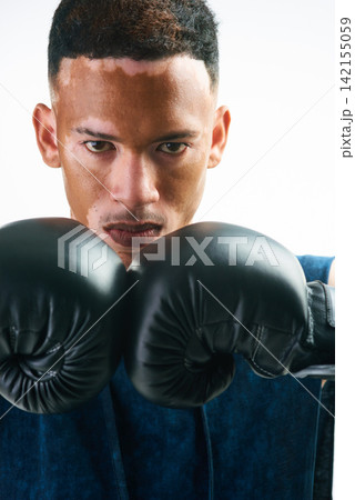 Boxing, fitness and portrait of man in studio with sports, attitude and resilience, never give up and mindset on white background. Face, gym or warrior with training, motivation or vitiligo awareness Boxing, fitness and portrait of man in studio with sports, attitude and resilience, never give up and mindset on white background. Face, gym or warrior with training, motivation or vitiligo awareness 142155059