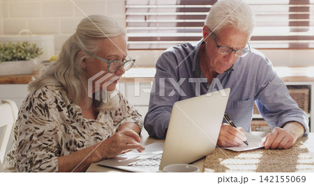 Elderly couple, laptop and kitchen for research, financial budget and online investment for mortgage payment in retirement. Man, woman and serious with tech and paperwork or planning internet banking 142155069