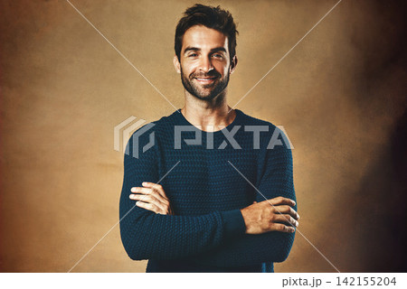 Portrait, man and fashion in studio for confidence for modeling, designer brand and hipster style. Handsome face, smile and model by brown background for winter clothes, cool hair and casting agency Portrait, man and fashion in studio for confidence for modeling, designer brand and hipster style. Handsome face, smile and model by brown background for winter clothes, cool hair and casting agency 142155204